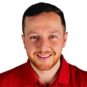 Man wearing a red shirt with a plain background